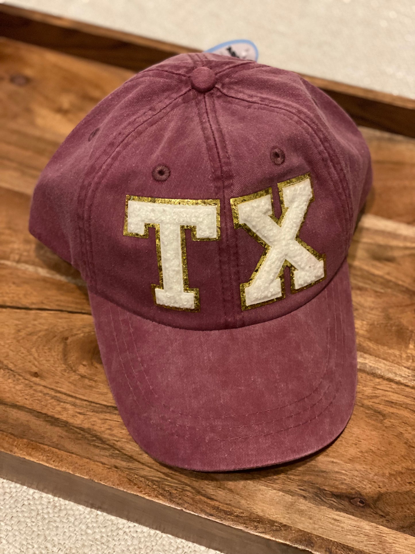 TX maroon baseball cap